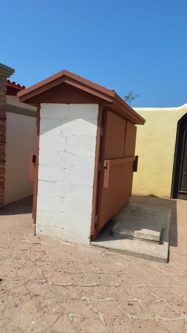 Newly rebuilt módulo housing with fresh paint and a pitched wood roof, front view